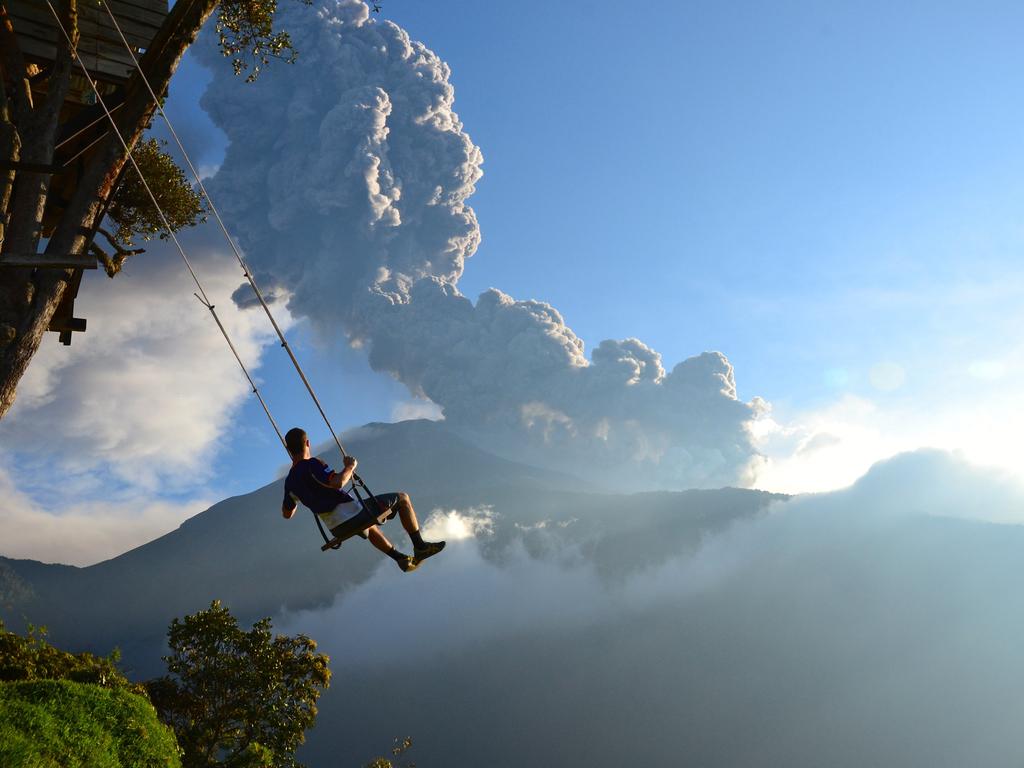 “End of the World” by Sean Hacker Teper / National Geographic Traveler Photo Contest This photo, taken at the ‘end of the world’ swing in Banos, Ecuador, captures a man on the swing overlooking an erupting Mt. Tungurahua. The eruption took place on February 1st, 2014. Minutes after the photo was taken, we had to evacuate the area because of an incoming ash cloud. Location: Banos, Ecuador. Picture: <a href="http://travel.nationalgeographic.com/travel/traveler-magazine/photo-contest/2014" target="_blank">National Geographic Photo Contest </a>