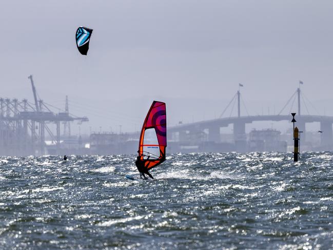 MELBOURNE, AUSTRALIA - NewsWire Photos October 10, 2021:  Kite surfers and sailboards on Port Phillip Bay with Port Melbourne and the West gate Bridge in the background. Picture: NCA NewsWire / David Geraghty