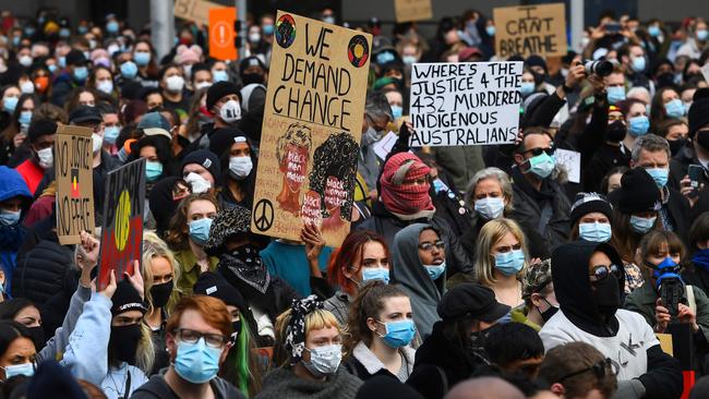 People hold up placards at a Black Lives protest in Melbourne. Picture: William West/AFP