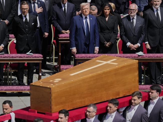 The coffin of Pope Francis is carried in front of dignitaries, including President Donald Trump, center, during his funeral in St. Peter's Square at the Vatican, Saturday, April 26, 2025. (AP Photo/Gregorio Borgia)