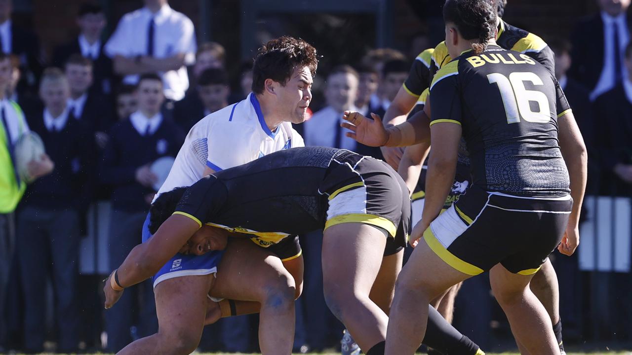 St Dominics’ Connor Autagavaia is hit hard by the Bass defence. Pic: Richard Dobson.