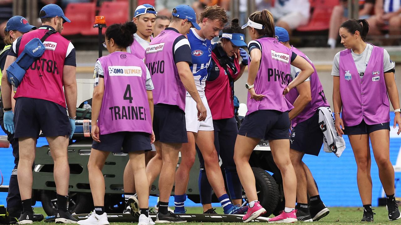 He managed to walk from the ground with the help of trainers. (Photo by Matt King/AFL Photos/via Getty Images )