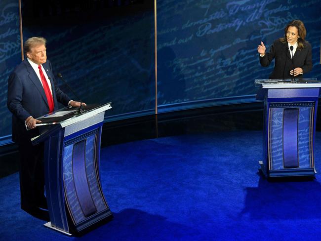 TOPSHOT - US Vice President and Democratic presidential candidate Kamala Harris (R) speaks as former US President and Republican presidential candidate Donald Trump listens during a presidential debate at the National Constitution Center in Philadelphia, Pennsylvania, on September 10, 2024. (Photo by SAUL LOEB / AFP)