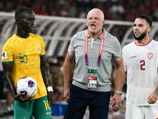 Frustrated Socceroos coach Graham Arnold (centre) reacts to a referee’s decision as Australia's Awer Mabil (left) and Indonesia's Calvin Verdonk wait for play to restart during the 0-0 draw in Jakarta. Picture: Aditya Aji / AFP