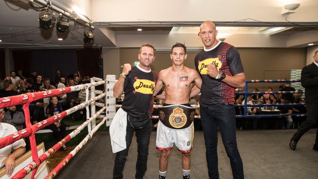 Beerwah fighter Dana Coolwell was crowned Queensland State Lightweight champion on Saturday. He is pictured with Shaun Halley (left) and trainer Stephen Pitt (right). Picture: Marty_Camilleri