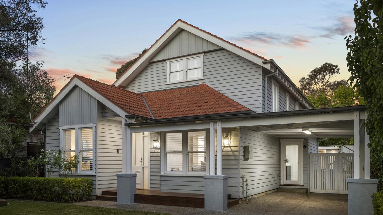 The exterior of the Higgins’ family home features a charming picket fence, landscaped gardens, and a classic facade.