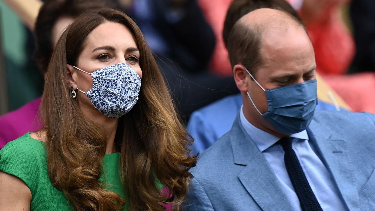 Catherine, Duchess of Cambridge and Britain's Prince William, Duke of Cambridge, wearing face masks, take their sets in the Royal box to watch the women's singles final at the 2021 Wimbledon Championships. (Photo by Glyn KIRK / AFP)