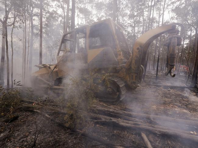 Some heavy plant operators are hundreds of thousands of dollars out of pocket after helping to build vital containment lines. Picture: AP