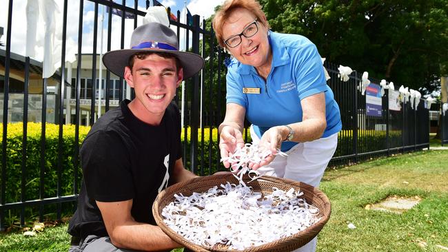 Ignatius Park College year 11 student Wayne Owens, 16, holds the 1100 white ribbons which Soroptimist Group volunteer Janet Askern made with the help of fellow group members. Picture: Shae Beplate.