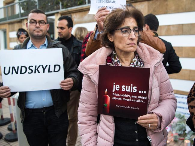 A man holds a placard with the Danish word for ‘sorry’ next to a woman whose sign reads: ‘I am sad, supportive, moved, afraid, shocked, upset’ at a vigil in front of the Danish embassy on December 22. Picture: Fadel Senna/AFP