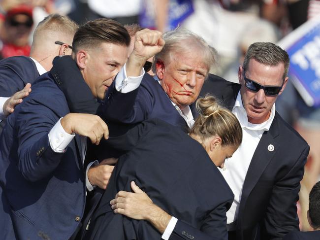 epa11476882 Former US President Donald Trump is rushed off stage by secret service after an incident during a campaign rally at the Butler Farm Show Inc. in Butler, Pennsylvania, USA, 13 July 2024. Former US President Donald Trump stated on social media that a bullet pierced the upper part of his right ear and that a person attending the rally was killed, another was injured and that the alleged shooter was dead. EPA/DAVID MAXWELL