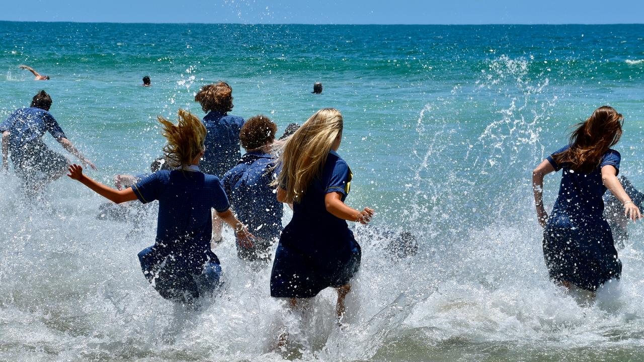 Year 12 graduates from schools across the Sunshine Coast hit to the water at Mooloolaba Beach to celebrate the end of their schooling. Photo: Mark Furler