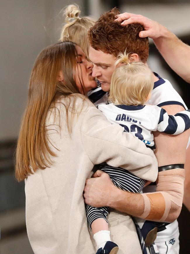 Gary Rohan and partner Madi Bennett embrace as he enters the field for his 150th match with his daughters Bella and Sadie.