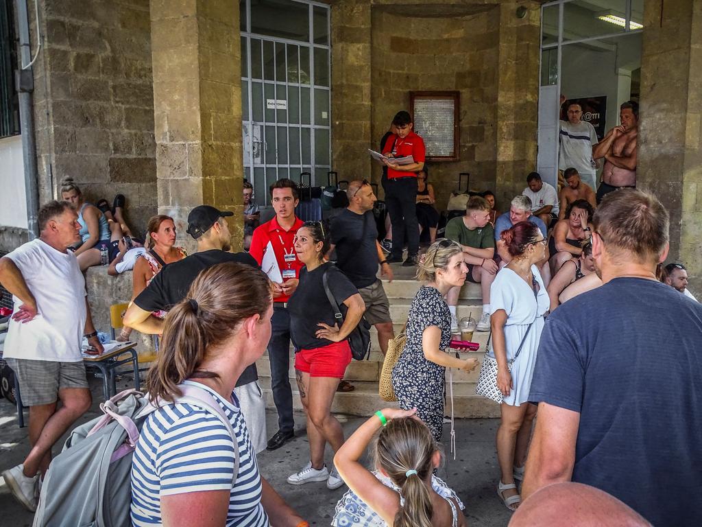 Tourists stand outside a school where they spent their night due to the wildfire in Rhodes. Picture: AFP