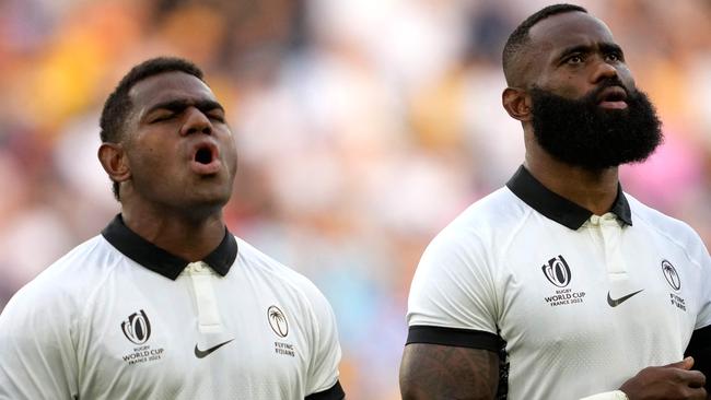 Fiji's left wing Semi Radradra (R) and Fiji's inside centre Josua Tuisova (L) stand during the national anthems ahead of the France 2023 Rugby World Cup Pool C match between Australia and Fiji at Stade Geoffroy-Guichard in Saint-Etienne, south-eastern France on September 17, 2023. (Photo by Francis BOMPARD / AFP)