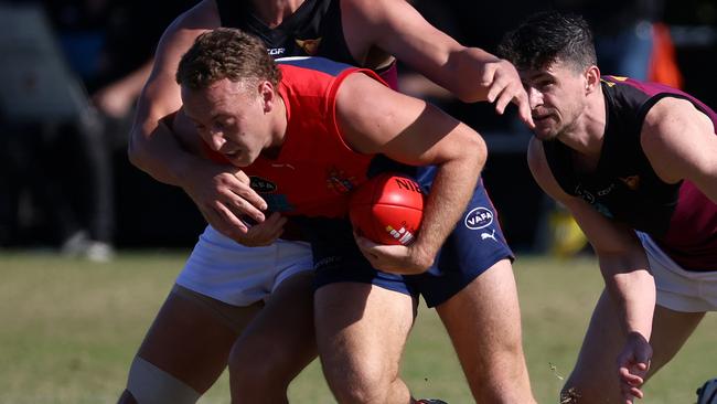 Old Brighton’s Thomas Fisher fights through the pack. Picture: Hamish Blair