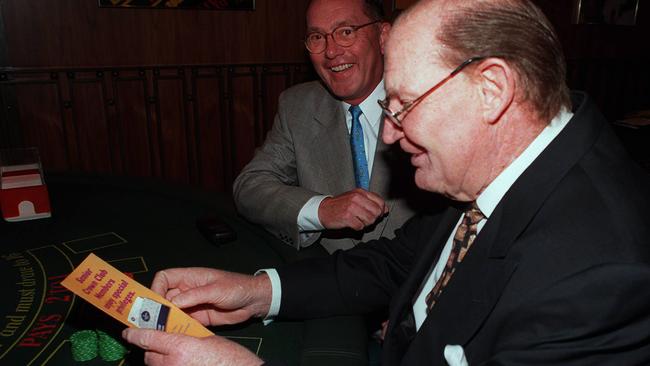 Crown Casino croupier Neroli Burke at Blackjack table watches as boss Lloyd Williams give businessman and casino's major shareholder Kerry Packer a form to join Crown Senior Citizens Club in 1997.