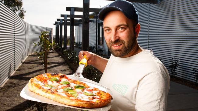 Chef Ettore Bertonati with a paddle of pizza pinsa. Picture: Matt Turner