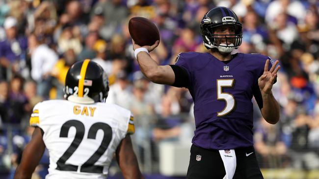 Quarterback Joe Flacco #5 of the Baltimore Ravens passes the ball while under pressure.