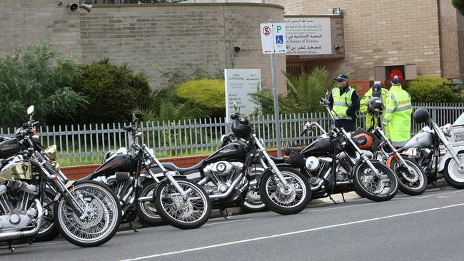 Cops stand next to the motorbikes at Preston Mosque.