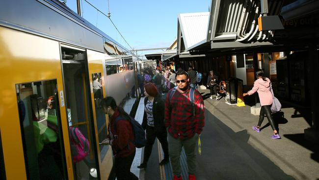 Commuters jump on board one of the newer trains.