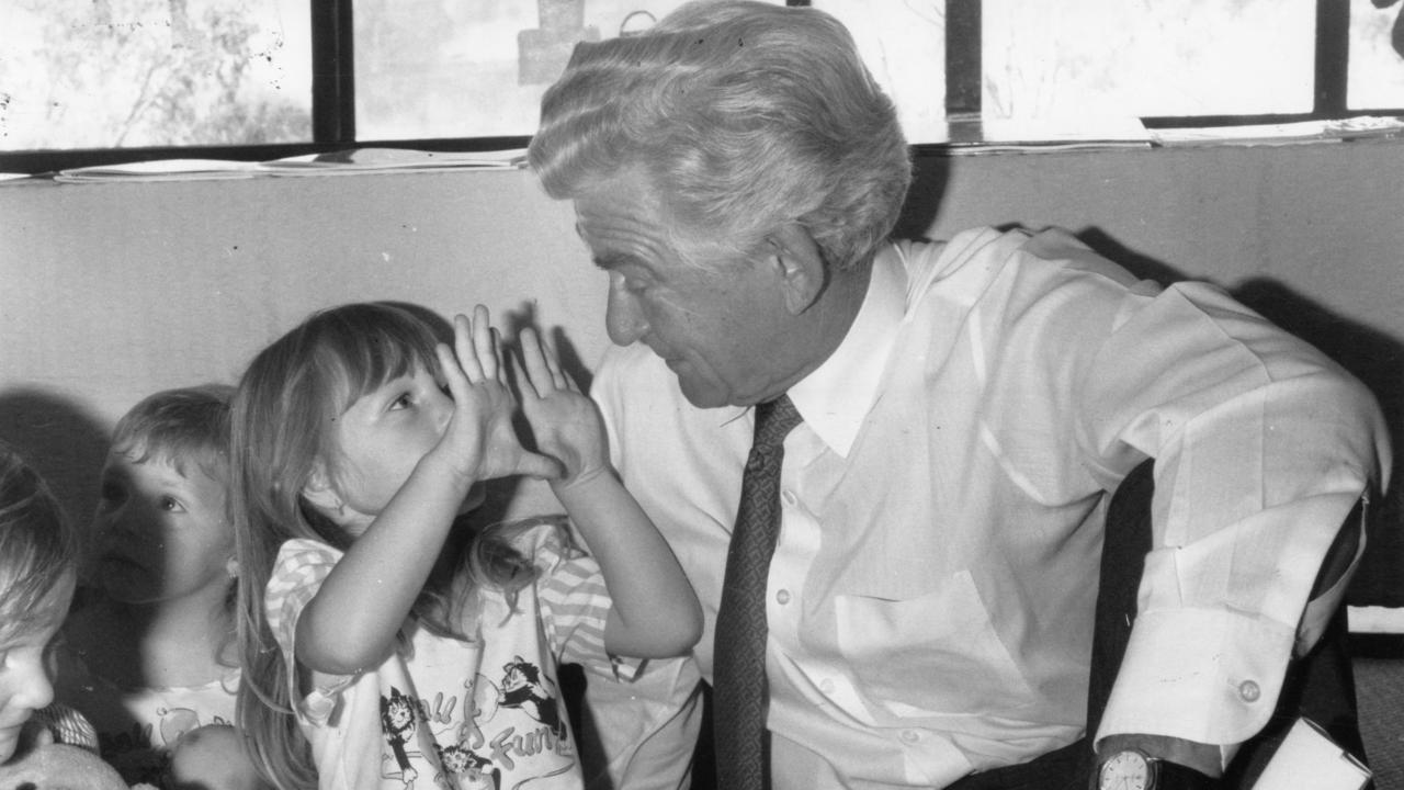 Former PM Bob Hawke sits down with little girl, Kristy Cox, 3, at the opening of a community creche at Noarlunga while campaigning in 1990.