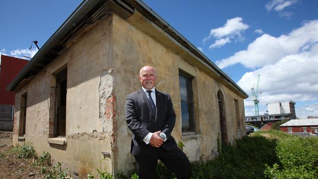 Real estate agent Marcus Freebody in front of the heritage listed property at 40a Patrick St, in central Hobart, which is coming up for auction. Picture: MATT THOMPSON