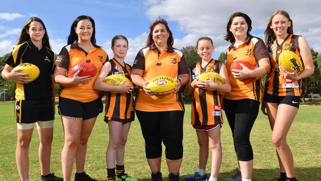 Hackham footballers Jess Harris, Courtnie Noble, Hope Rowe, Charmaine Mulloy, Ebony Woodward, Natalie Keane and Abby Woodward. They will wear pink armbands and socks this Sunday to raise money for Breast Cancer Network Australia after Keane was diagnosed in 2015. Picture: AAP/Keryn Stevens