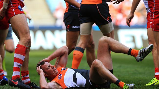 Steve Johnson gets knocked down by the Swans. Picture: Toby Zerna