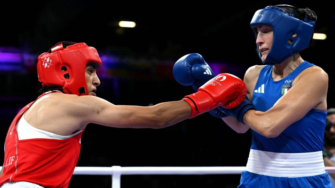 Khelif throws a right hand on Carini. (Photo by MOHD RASFAN / AFP)