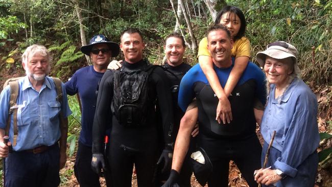 Yang Chen with rescuers after being found on Monday. Picture: QLD Police.