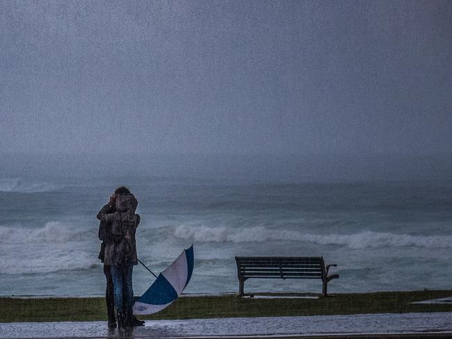 A day you don’t normally see, raining and windy. These two lovers weren’t going to let anything get in the way of a cheeky kiss. Picture: Jonathan Armstrong