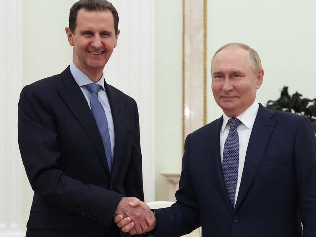 (FILES) In this file pool photograph distributed by the Russian state agency Sputnik, Russia's President Vladimir Putin (R) shakes hands with his Syrian counterpart Bashar al-Assad during their meeting at the Kremlin in Moscow on July 24, 2024. Islamist-led rebels declared that they have taken Damascus in a lightning offensive on December 8, 2024 sending President Bashar al-Assad fleeing and ending five decades of Baath rule in Syria. (Photo by Valery SHARIFULIN / POOL / AFP) / Editor's note : this image is distributed by Russian state owned agency Sputnik