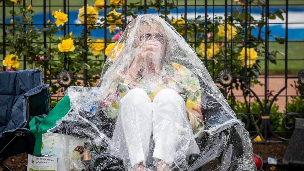 Melbourne Cup. 2022. People prepare for rain. Picture: Jake Nowakowski