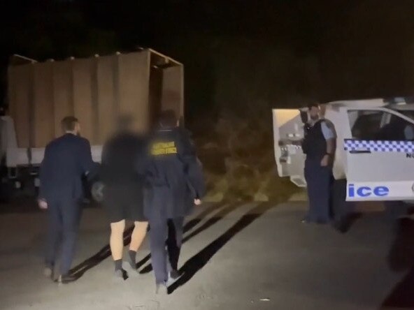 Australian Border Force officers and NSW police arrest Desmond Jethro Higgins at Waratah after an investigation into the alleged attempted important of a child sex doll. Picture: ABF.