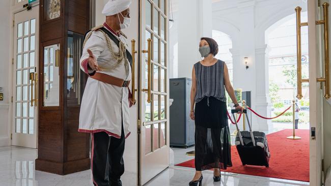 Doorman Sukkhdev Singh greets a guest at Raffles Hotel in Singapore on Wednesday. Picture: Feline Lim