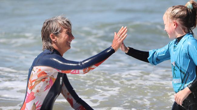 Layne Beachley with Bella Kay 9 of Hobart. Former world champion surfer Layne Beachley at the Women in Waves day at Clifton Beach. Picture: Nikki Davis-Jones