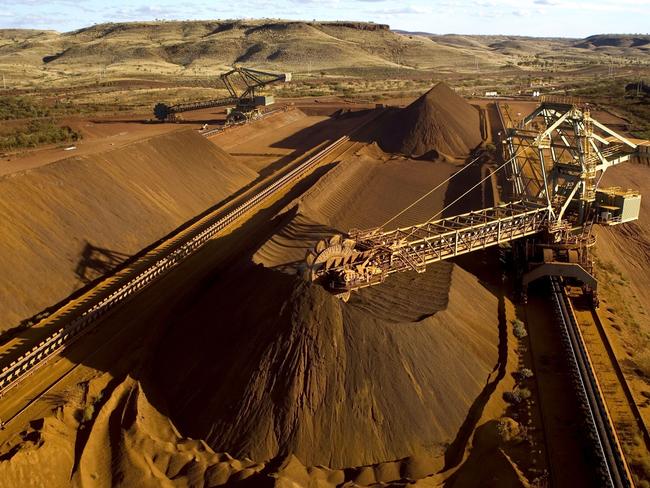 (FILES) This undated file handout photo released on September 4, 2009 by Rio Tinto shows a reclaimer working in the Yandicoogina stockyard and loading a conveyor with high grade iron ore in Western Australia's Pilbara region. Rio Tinto rewarded shareholders on February 7, 2018 with a record dividend as the mining giant reported a bumper annual net profit of 8.76 billion USD in 2017, a 90 percent jump as commodity prices strengthened. / AFP PHOTO / RIO TINTO / Handout / -----EDITORS NOTE --- RESTRICTED TO EDITORIAL USE - MANDATORY CREDIT 