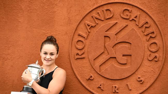 (FILES) In this file photograph taken on June 9, 2019, Australia's Ashleigh Barty poses with The Suzanne Lenglen Trophy on day fifteen of The Roland Garros 2019 French Open tennis tournament in Paris, after her victory the day before, in the women's singles final match against Czech Republic's Marketa Vondrousova. – Australia's Ashleigh Barty, 23, rose from the relative anonymity of 15th in the world at the end of 2018 to top the rankings a year later, winning the French Open and the WTA Finals along the way. Teenager Bianca Andreescu of Canada soared even more dramatically, from 178th to fifth in the world, beating Serena Williams in the final of the US Open to become the first Canadian to win a Grand Slam singles title. "NextGen is here," Andreescu announced during her winning run at Flushing Meadows. "You see a lot of young players doing really well right now and I think it's really good for the game," added Andreescu. "You see many fresh faces and I think we're only going to get better from here." (Photo by Martin BUREAU / AFP)