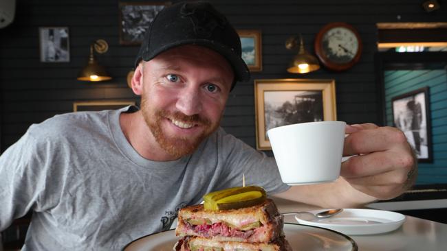 Mr PPs manager Daniel Jones with a Reubens toastie and a coffee. Picture: Glenn Hampson.