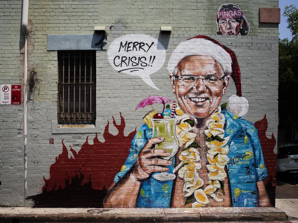 A Sydney mural by artist Scott Marsh depicting Prime Minister Scott Morrison on holiday in Hawaii. Picture: Jenny Evans/Getty Images