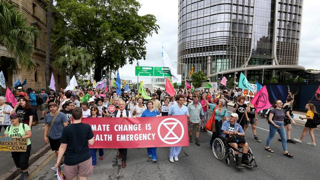 Extinction Rebellion Protesters march past Parliament House in Brisbane. Picture: Steve Pohlner