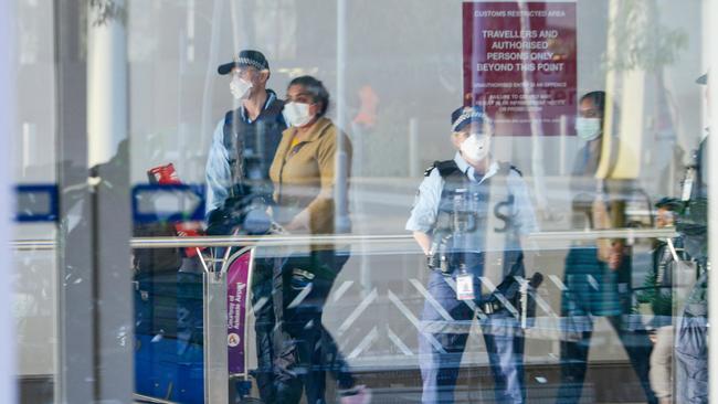 International travellers wear masks as they return to Adelaide. Picture: Brenton Edwards.