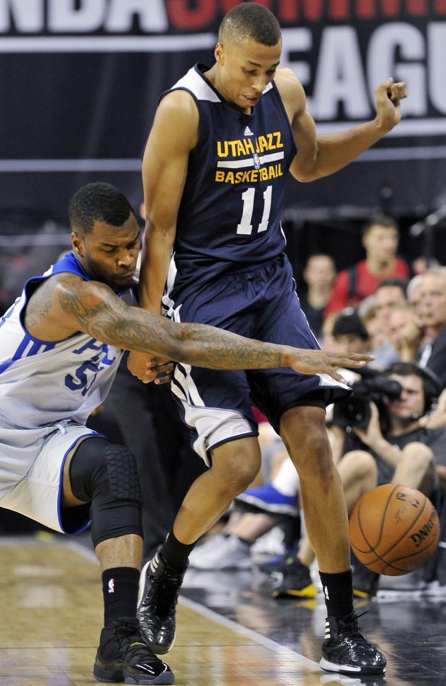 Philadelphia 76ers' Sean Kilpatrick attempts to grab a loose ball against Utah Jazz's Dante Exum.