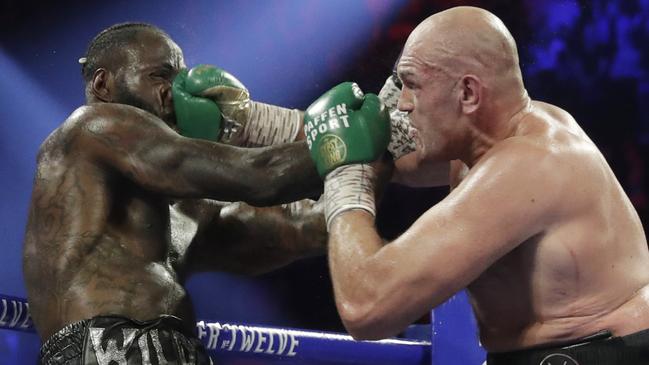 Tyson Fury lands a right hand on Deontay Wilder in their second fight. Picture: AP/Isaac Brekken