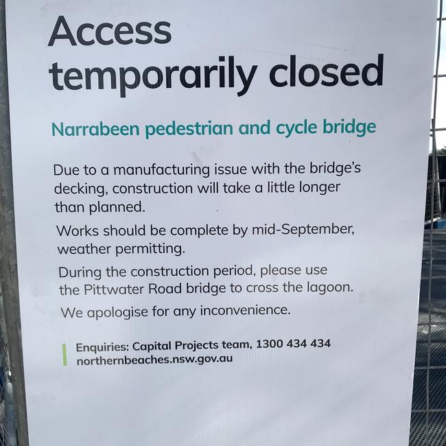 A notice placed by Northern Beaches Council on the new Narrabeen pedestrian and cycle bridge across the lagoon on Pittwater Rd, Narrabeen, alerting locals that the bridge is not completed. Picture: Manly Daily