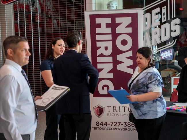 SUNRISE, FLORIDA - APRIL 30: Kiaraliz Irizarry (L) recruits people for jobs at Triton Recovery during the Mega JobNewsUSA South Florida Job Fair held in the Amerant Bank Arena on April 30, 2025 in Sunrise, Florida. Over 150 local hiring managers & recruiters were at the job fair to recruit workers for 1000s of positions in Miami, Broward, and Palm Beach County.   Joe Raedle/Getty Images/AFP (Photo by JOE RAEDLE / GETTY IMAGES NORTH AMERICA / Getty Images via AFP)