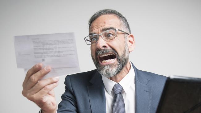 Furious business man shocked and angry with expensive bills he receives at his office, electricity money generic