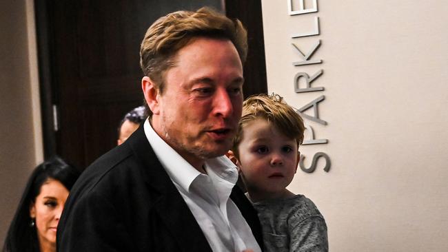 Twitter CEO Elon Musk holding one of his children. Picture: AFP