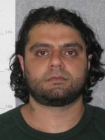 Prison photograph of Farhad Qaumi in 2012.